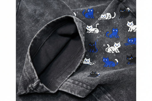 Close-up of a dark gray denim shirt with rolled-up sleeve