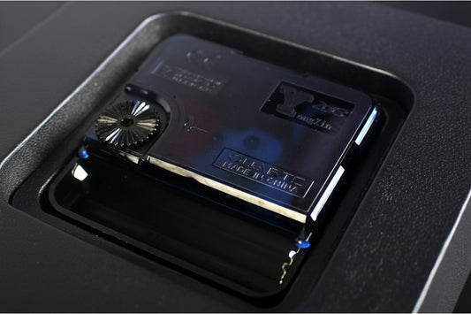 Close-up of a cassette tape with branding on a dark background