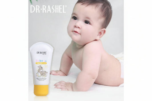 Baby with a bottle of Dr. Rashel baby lotion on a white background