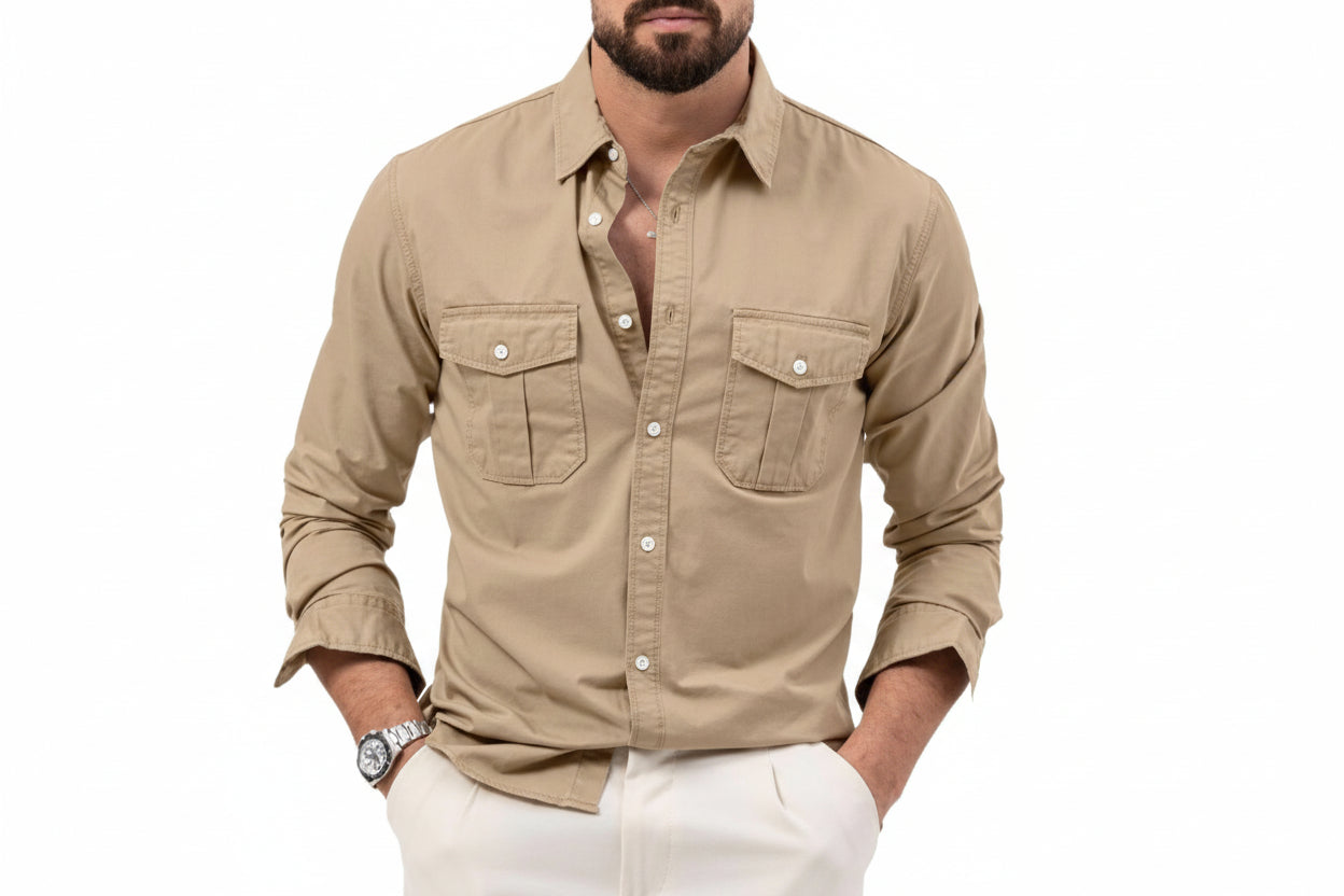 Man wearing a beige button-up shirt with white pants on a white background