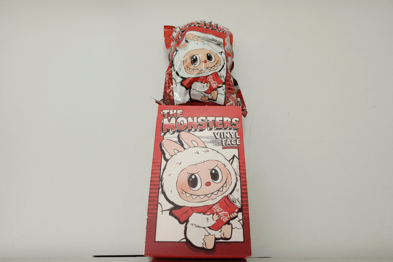 Two vinyl figures in red packaging with cartoon faces on a white background