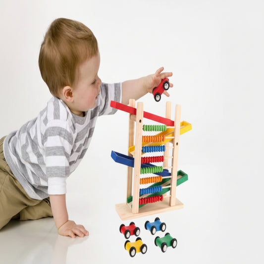 Child playing with a wooden abacus and toy cars on a white background