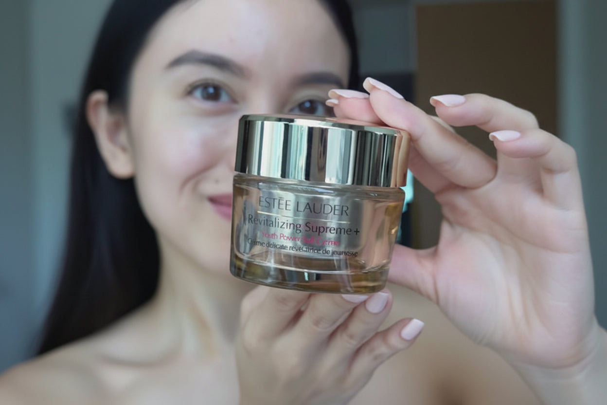 Estée Lauder Revitalizing Supreme+ Youth Power Soft Crème Moisturizer jar held by a person.