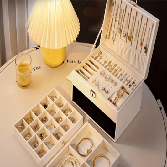 Jewelry organizer with various jewelry items on a table with a lamp in the background.