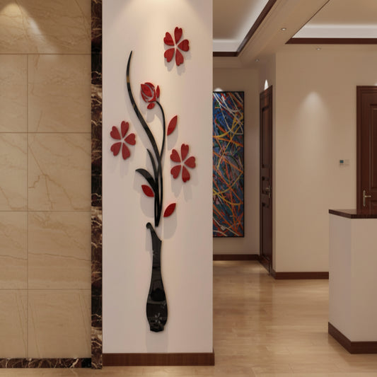 Decorative wall art with red flowers and a black vase on a white wall.