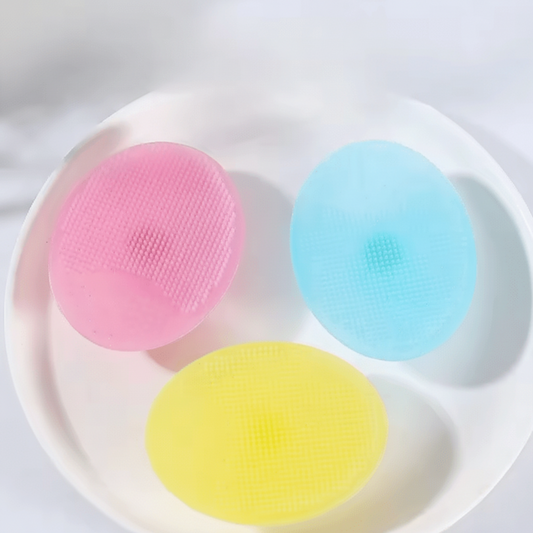 Three colorful silicone sponges on a white plate