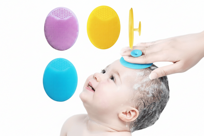 Baby being bathed with various silicone scrubbers on a white background