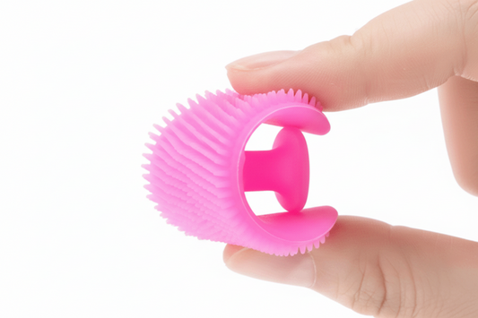 Pink silicone bottle stopper held by a hand against a white background
