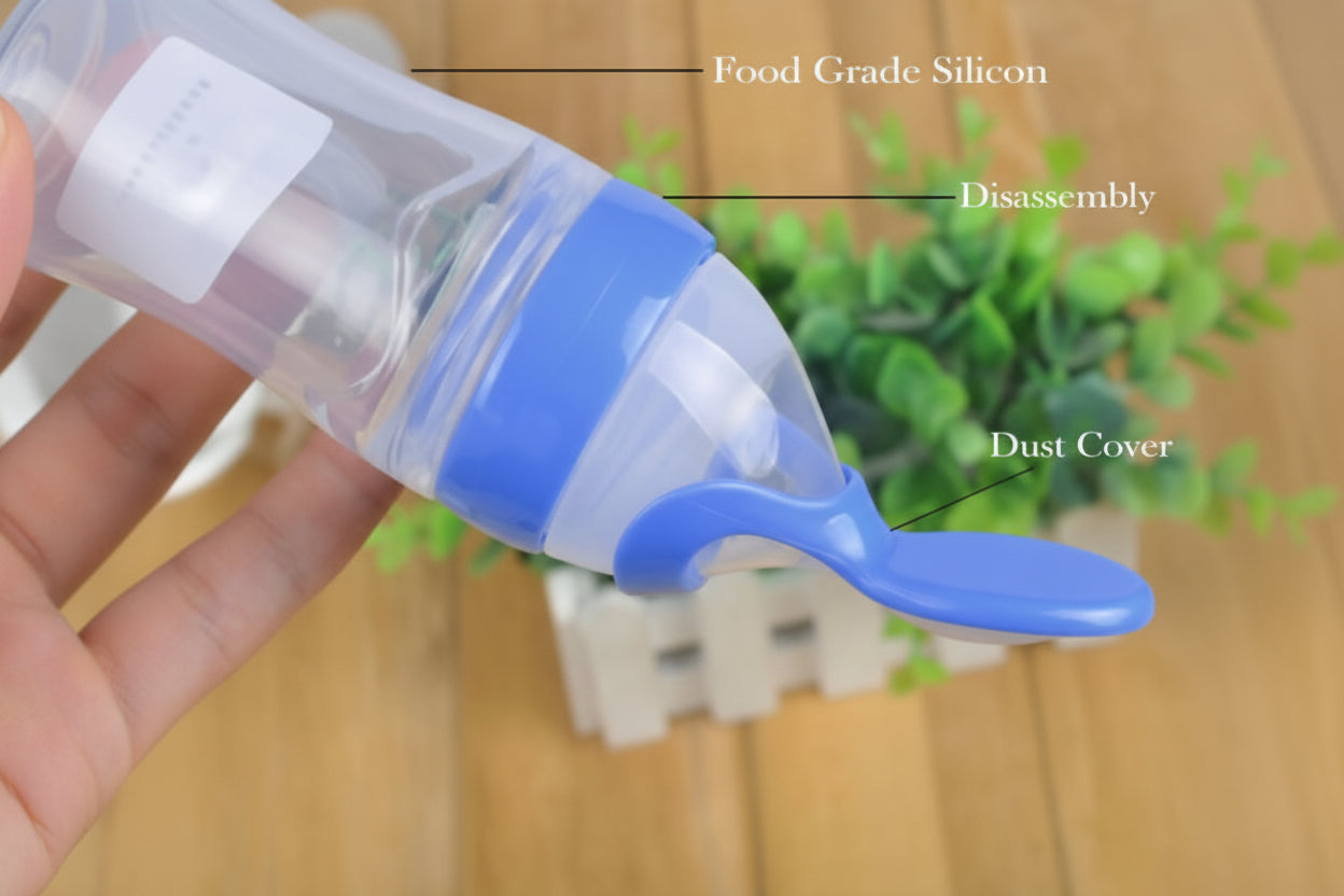 Blue and clear silicone food scoop with text labels on a blurred background