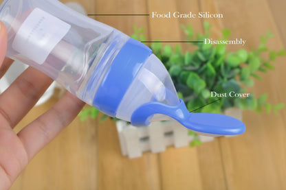 Blue and clear silicone food scoop with text labels on a blurred background