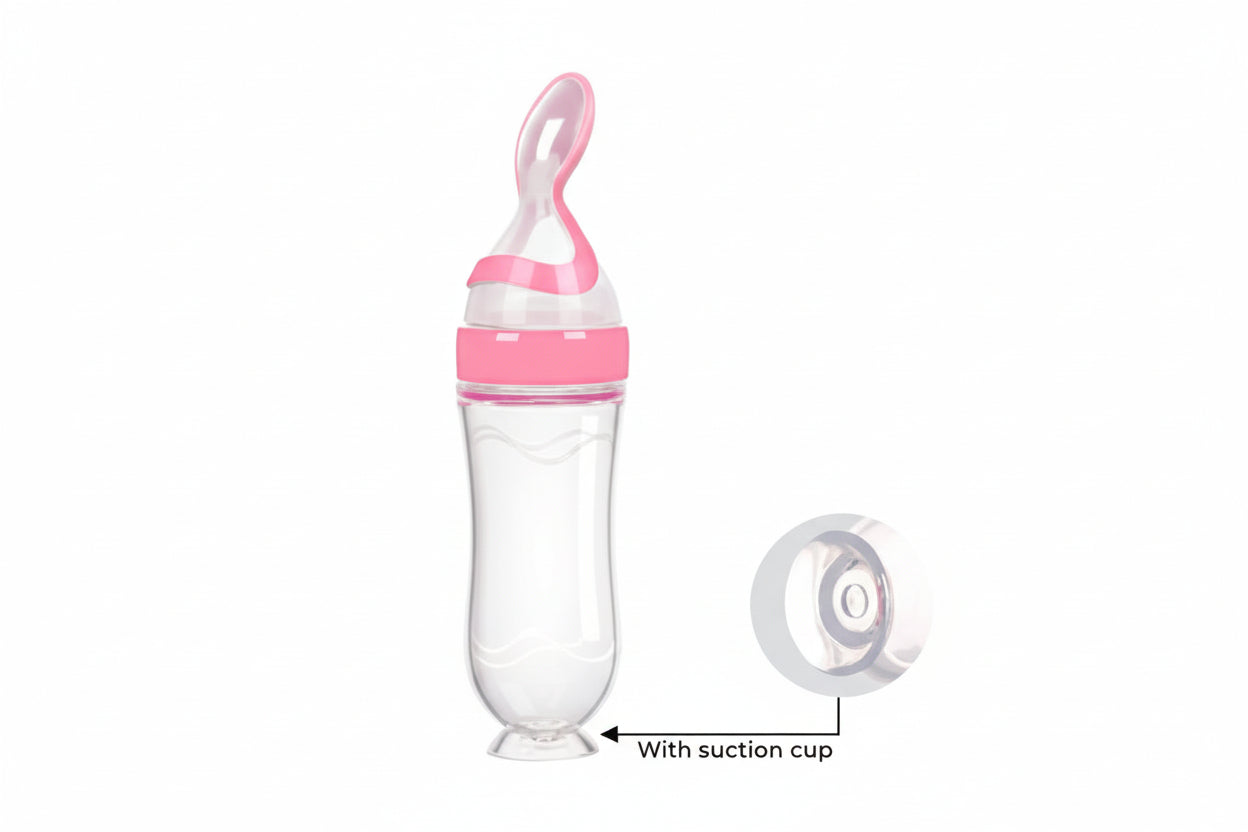 Pink and clear baby bottle with suction cup on a white background