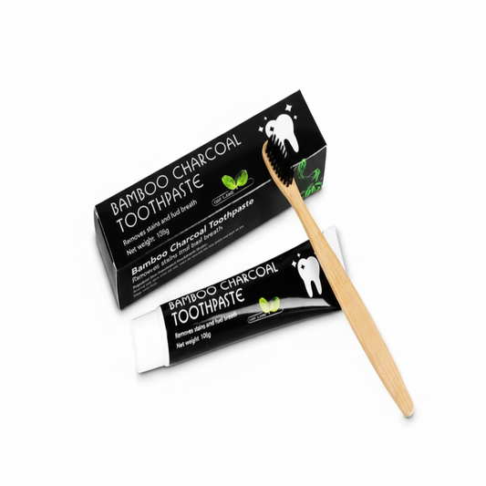 Bamboo charcoal toothpaste with packaging and a wooden toothbrush on a white background