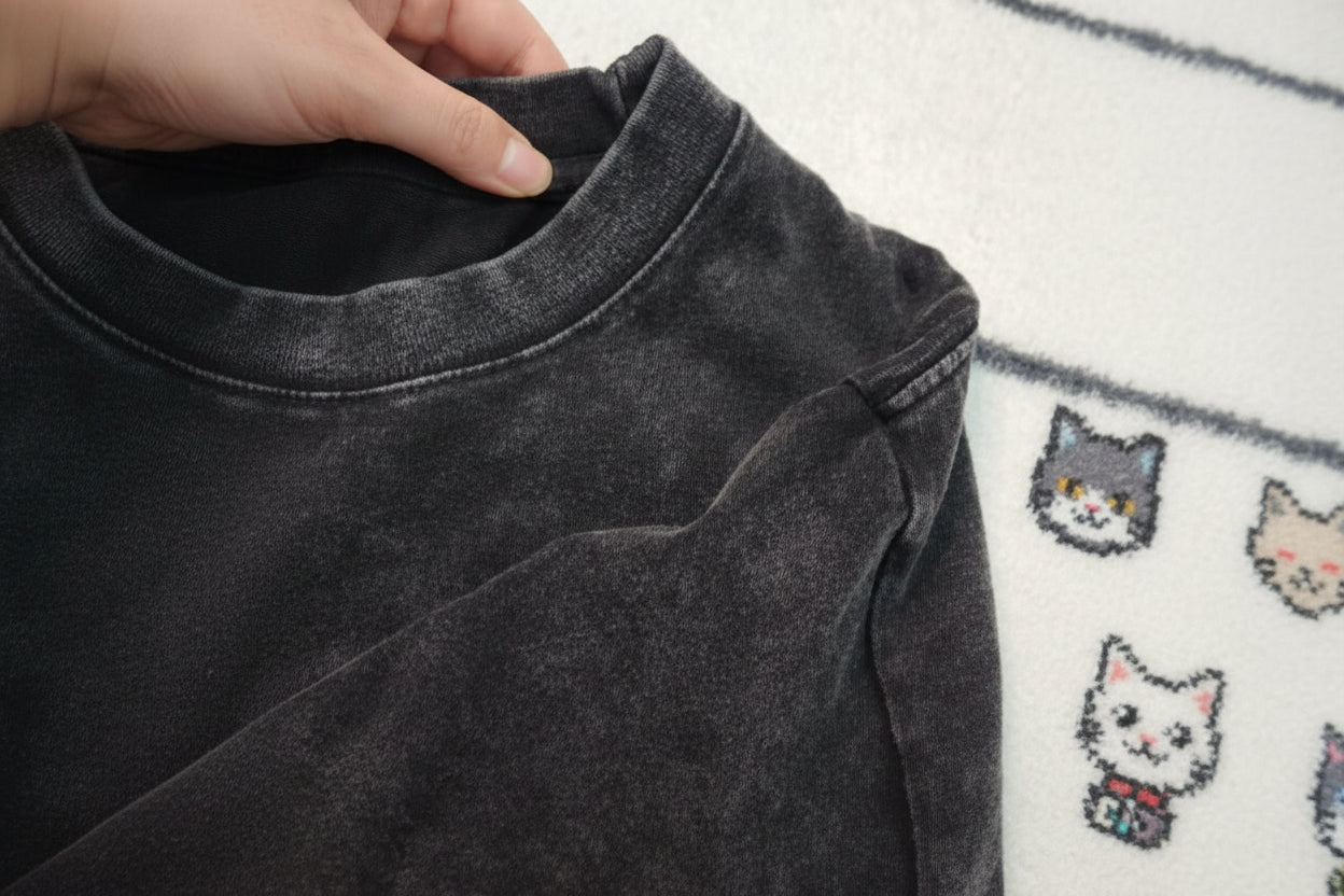 Close-up of a dark gray fabric with a textured surface.
