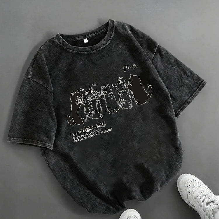 Black t-shirt with cat graphic design on a gray background