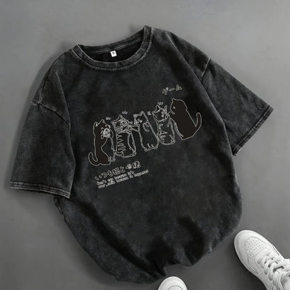 Black t-shirt with cat graphic design on a gray background