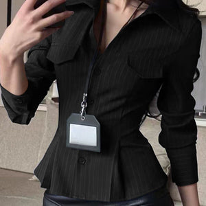 Person wearing a black pinstripe jacket with a name tag holder.