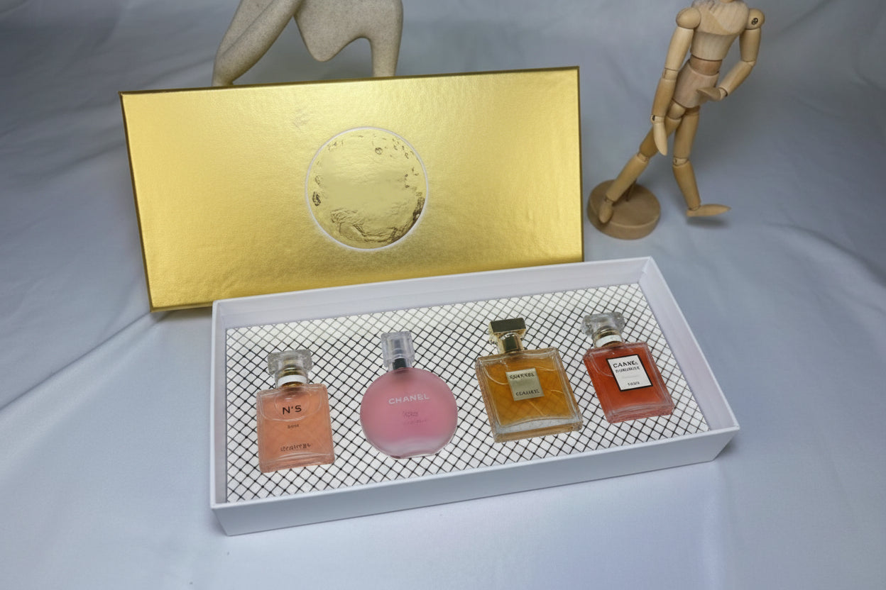 Set of three perfume bottles in a decorative box with a gold lid.