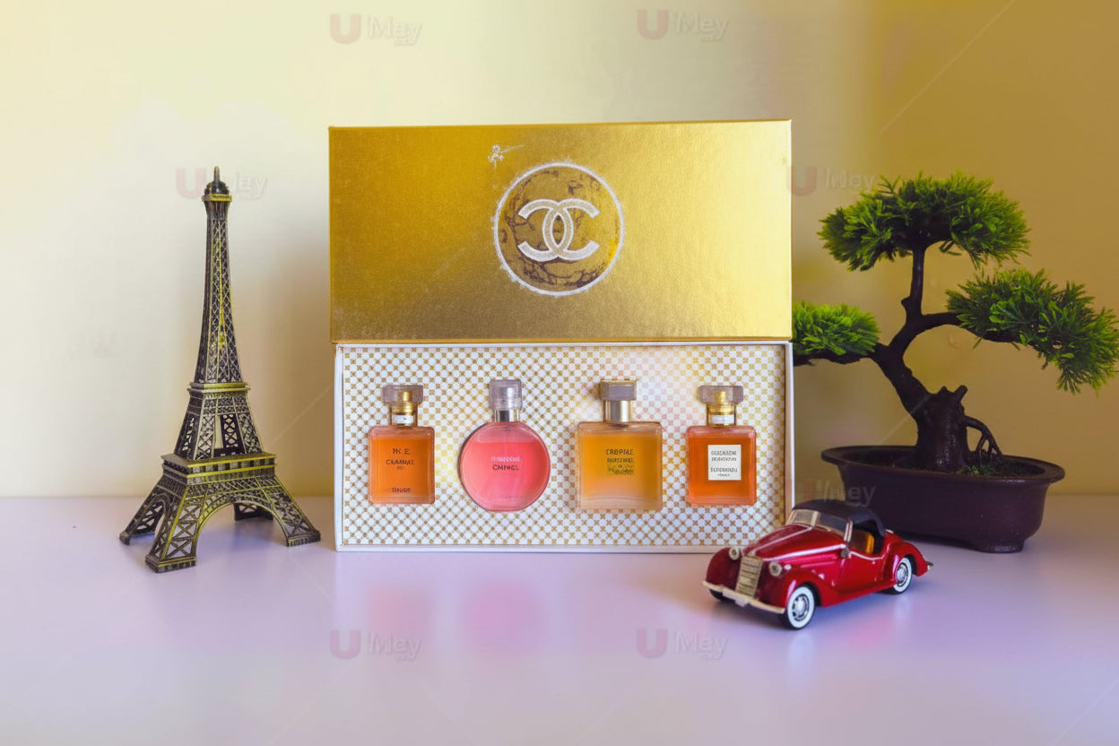Set of perfume bottles in a Chanel box with decorative items on a light background
