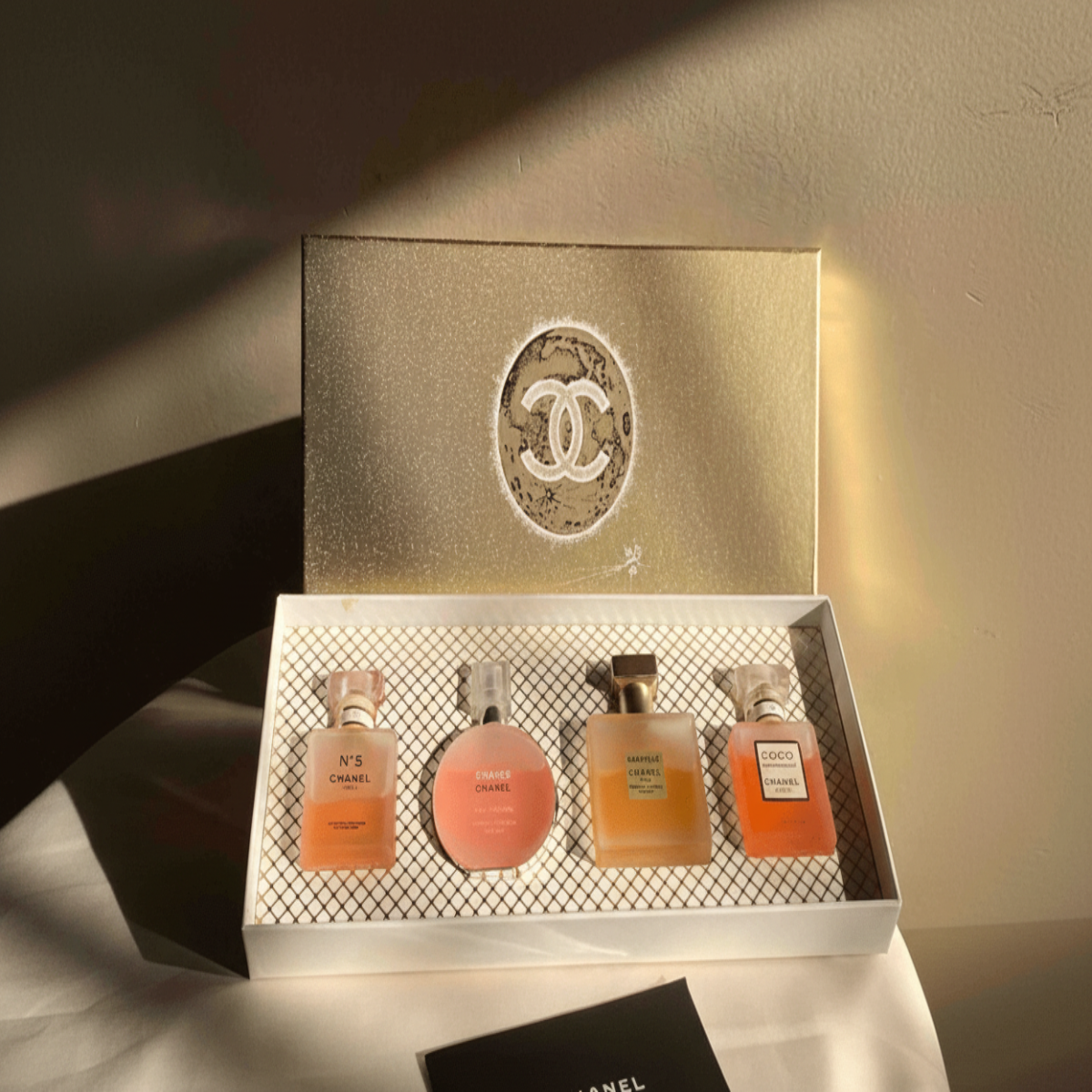 Set of Chanel perfume bottles in a decorative box with the brand logo.