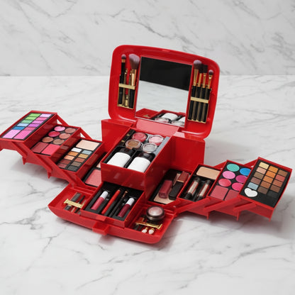 Red makeup set with various cosmetic items on a marble surface