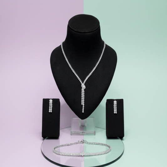 Jewelry set with necklace, earrings, and bracelet on a mannequin bust against a two-tone background.