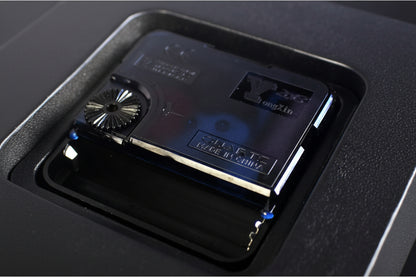 Close-up of a cassette tape with branding on a dark background