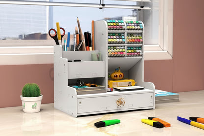 White desk organizer with stationery items in a room with large windows.