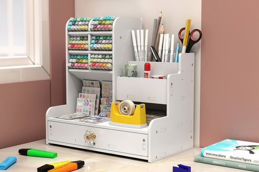 White desk organizer with stationery items on a wooden floor.