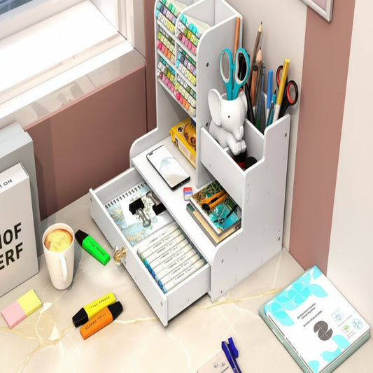 White desk organizer with stationery items on a desk near a window.
