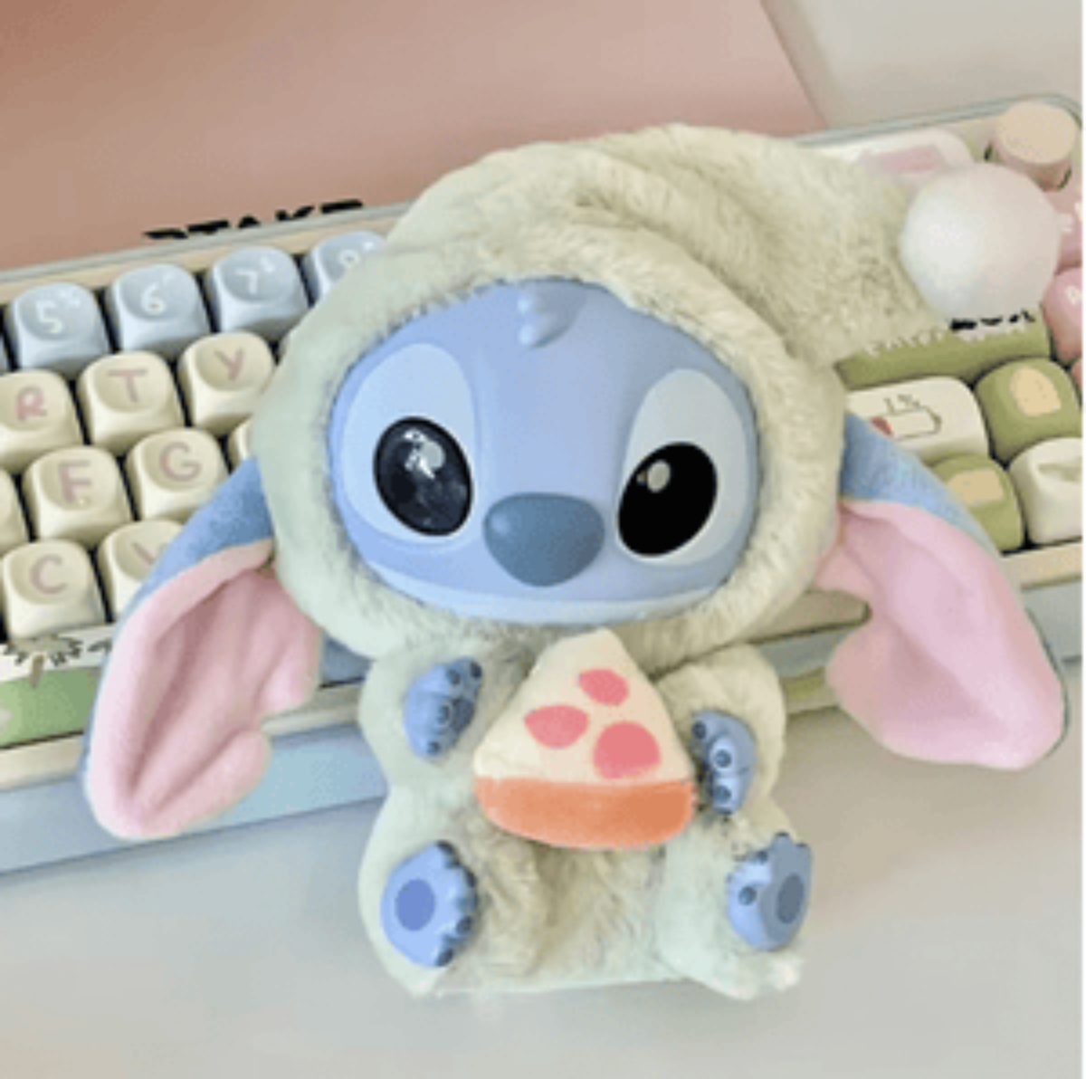 Plush toy resembling a character with a keyboard in the background