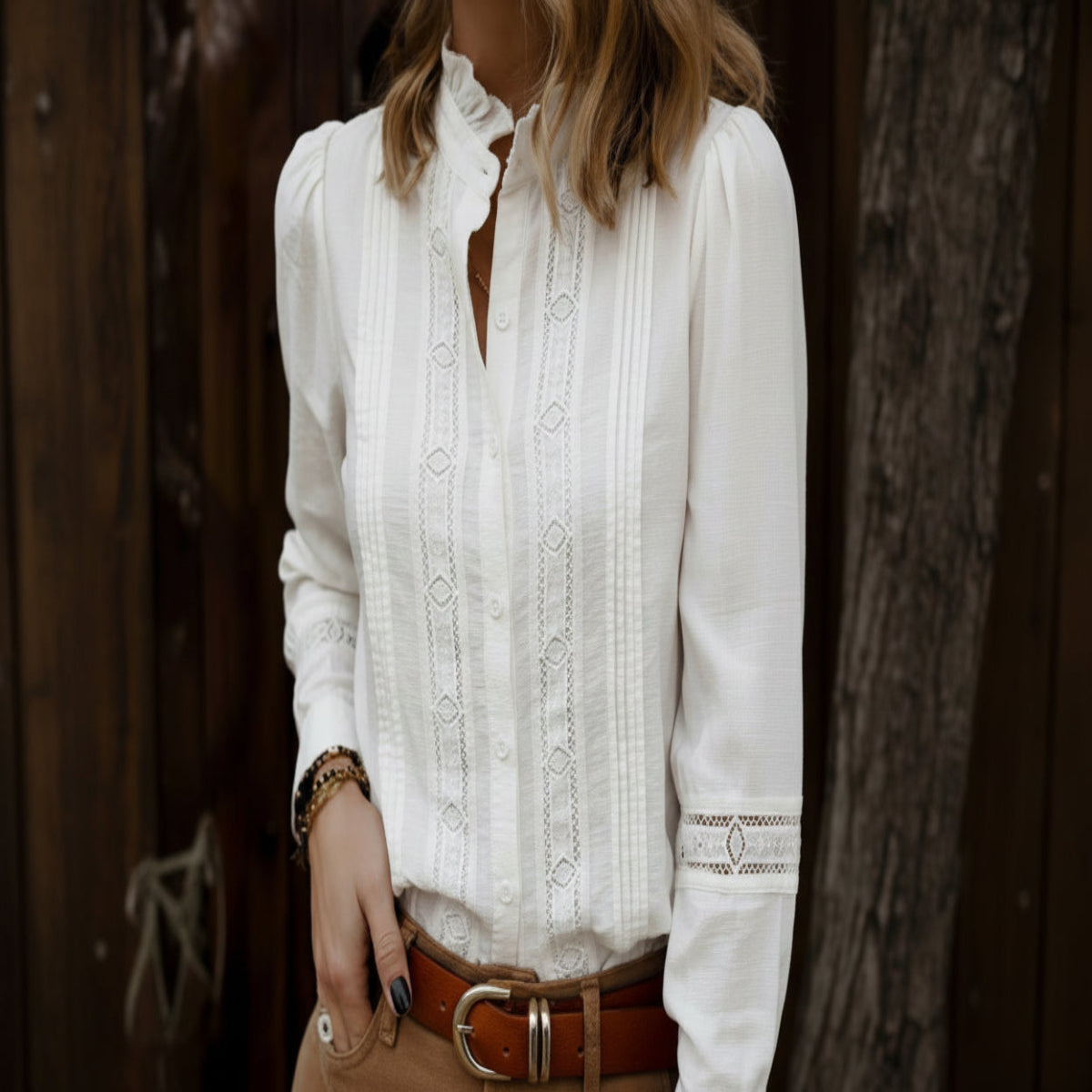 White embroidered blouse worn by a person with a blurred background