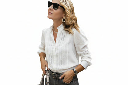 Woman wearing a white blouse with lace details on a white background