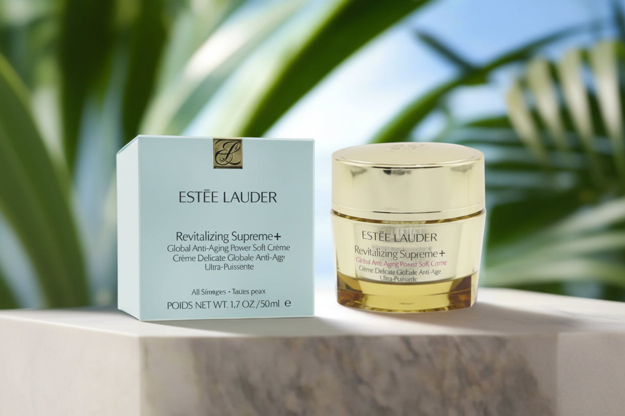 Estée Lauder Revitalizing Supreme+ cream jar and box on a blurred natural background