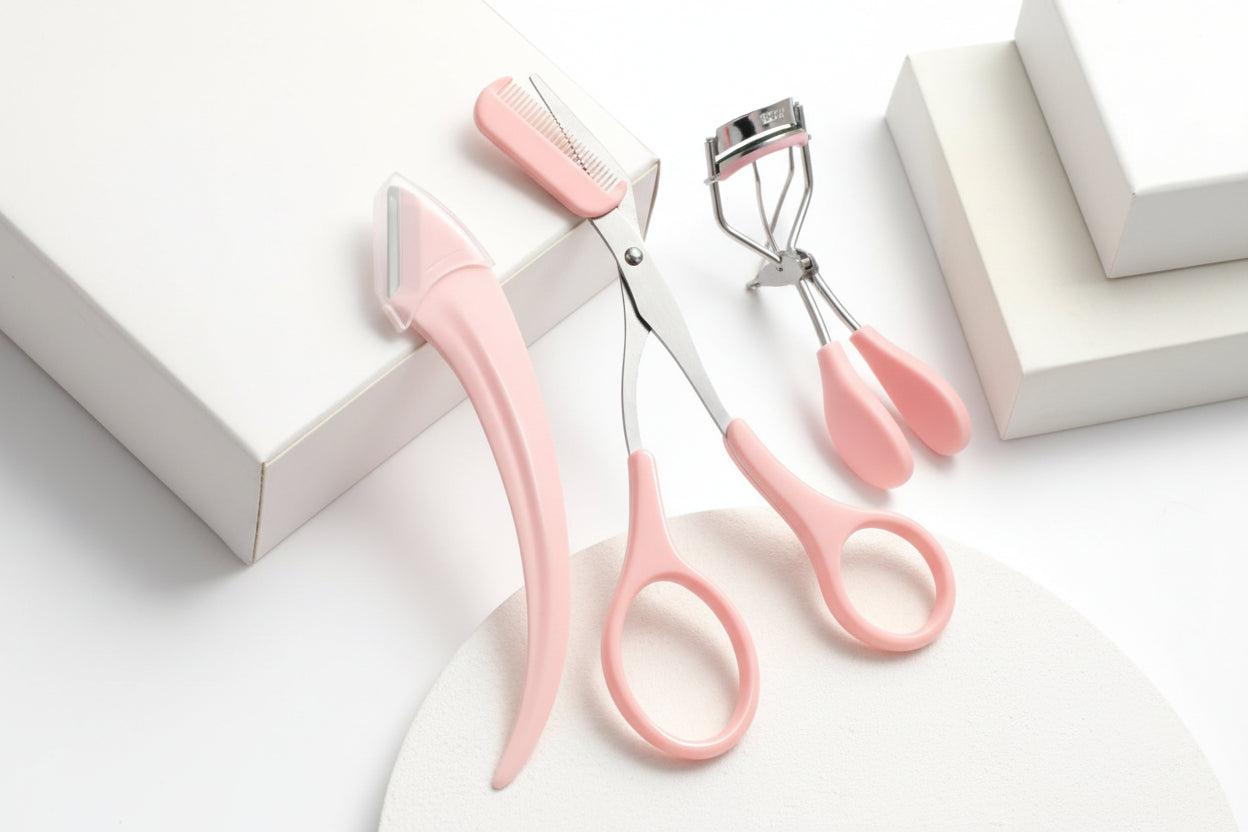 Pink pet grooming scissors with a comb on a white background
