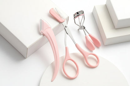 Pink pet grooming scissors with a comb on a white background