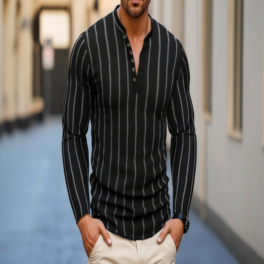 Man wearing a black pinstripe sweater with beige pants in an urban setting