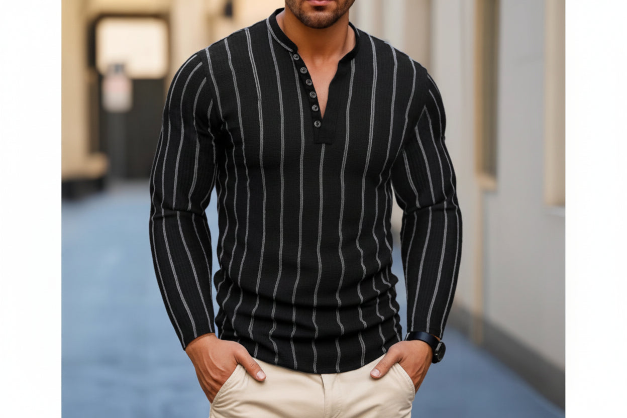 Man wearing a black pinstripe sweater with beige pants in an urban setting