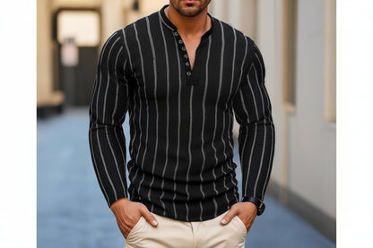 Man wearing a black pinstripe sweater with beige pants in an urban setting
