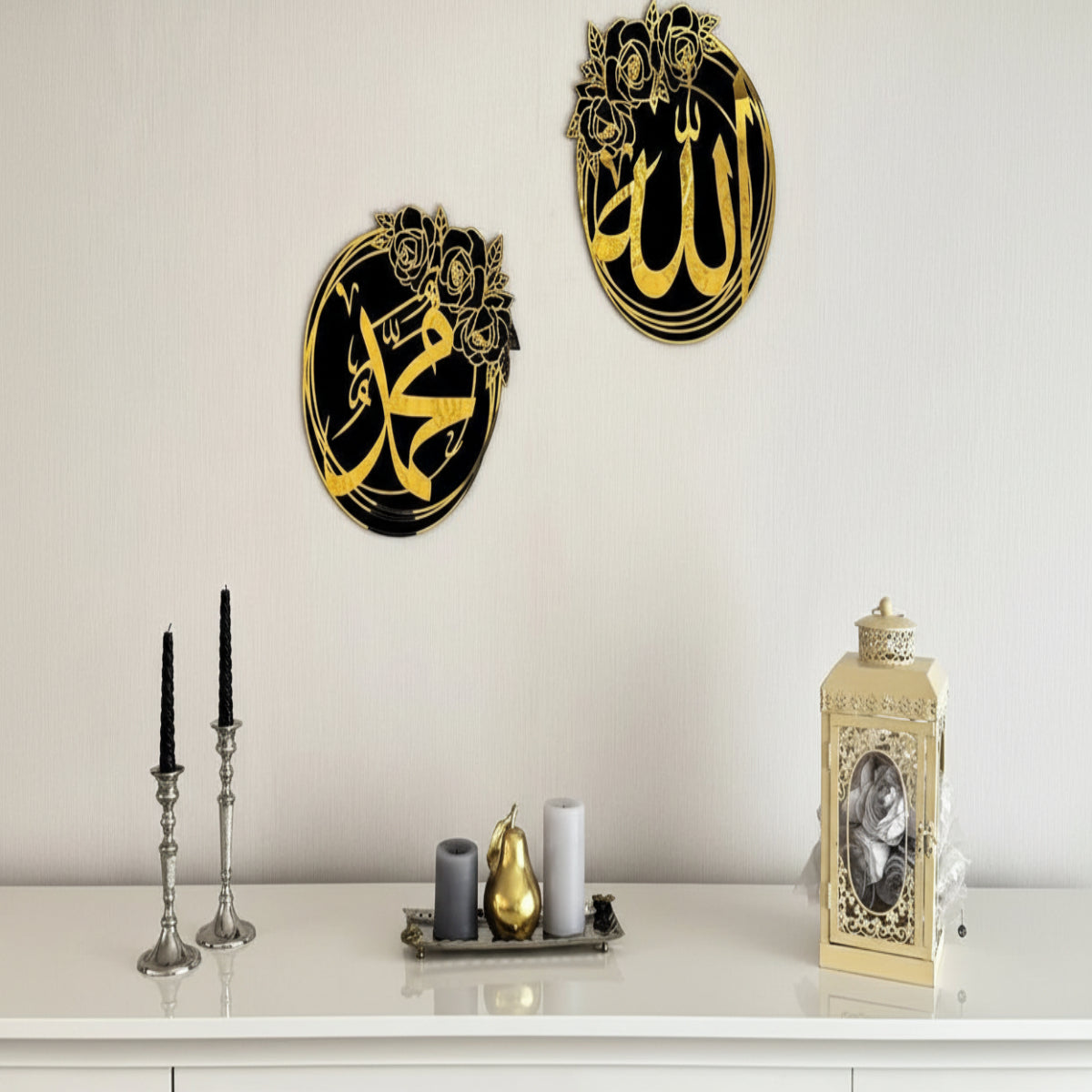 Decorative wall art with Arabic calligraphy on a white wall above a white cabinet.