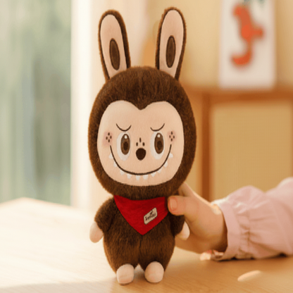 Plush toy with a cartoonish design held by a hand on a light surface.