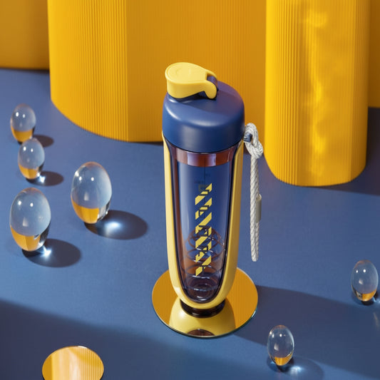 Blue and yellow water bottle with a keychain on a blue surface with yellow cylindrical objects in the background.