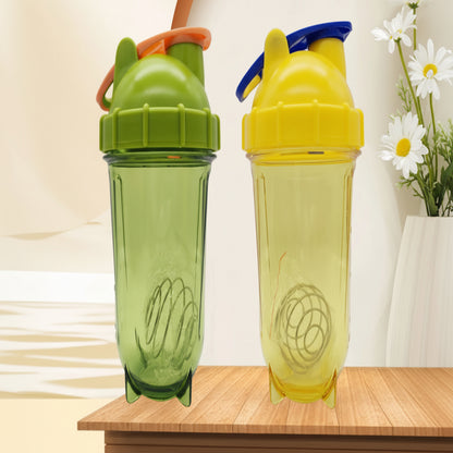 Two colorful shaker bottles on a wooden surface with a light background