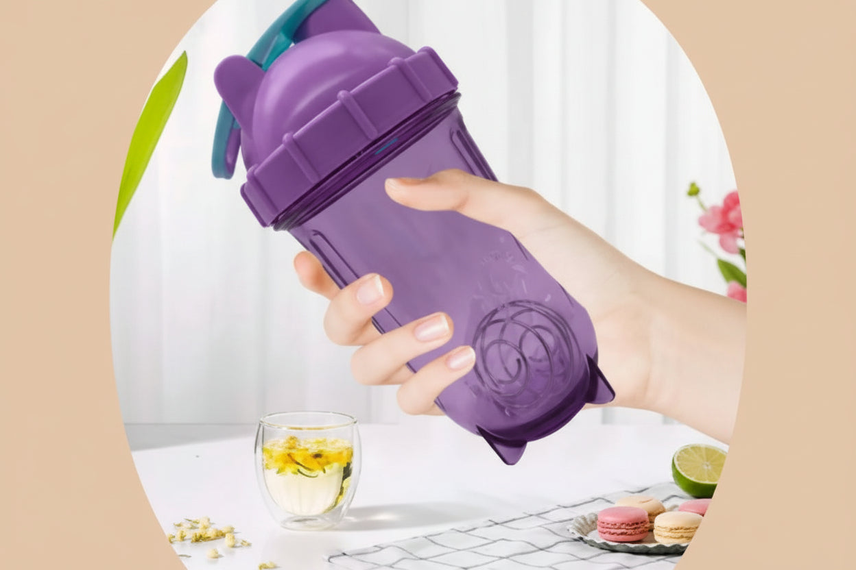 Hand holding a purple shaker bottle with a blurred background