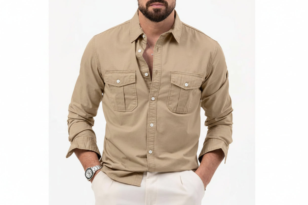 Man wearing a beige button-up shirt with white pants on a white background