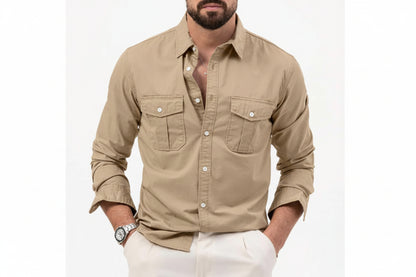 Man wearing a beige button-up shirt with white pants on a white background
