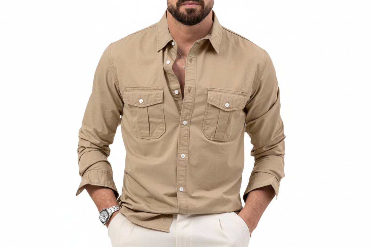 Man wearing a beige button-up shirt with rolled-up sleeves on a white background