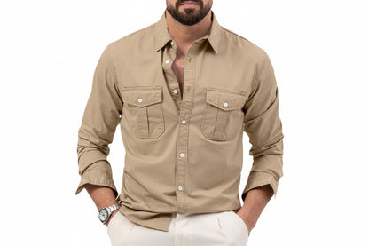 Man wearing a beige button-up shirt with rolled-up sleeves on a white background