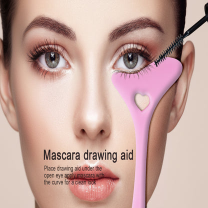 Mascara drawing aid with a heart-shaped guide on a close-up of a person's eye.