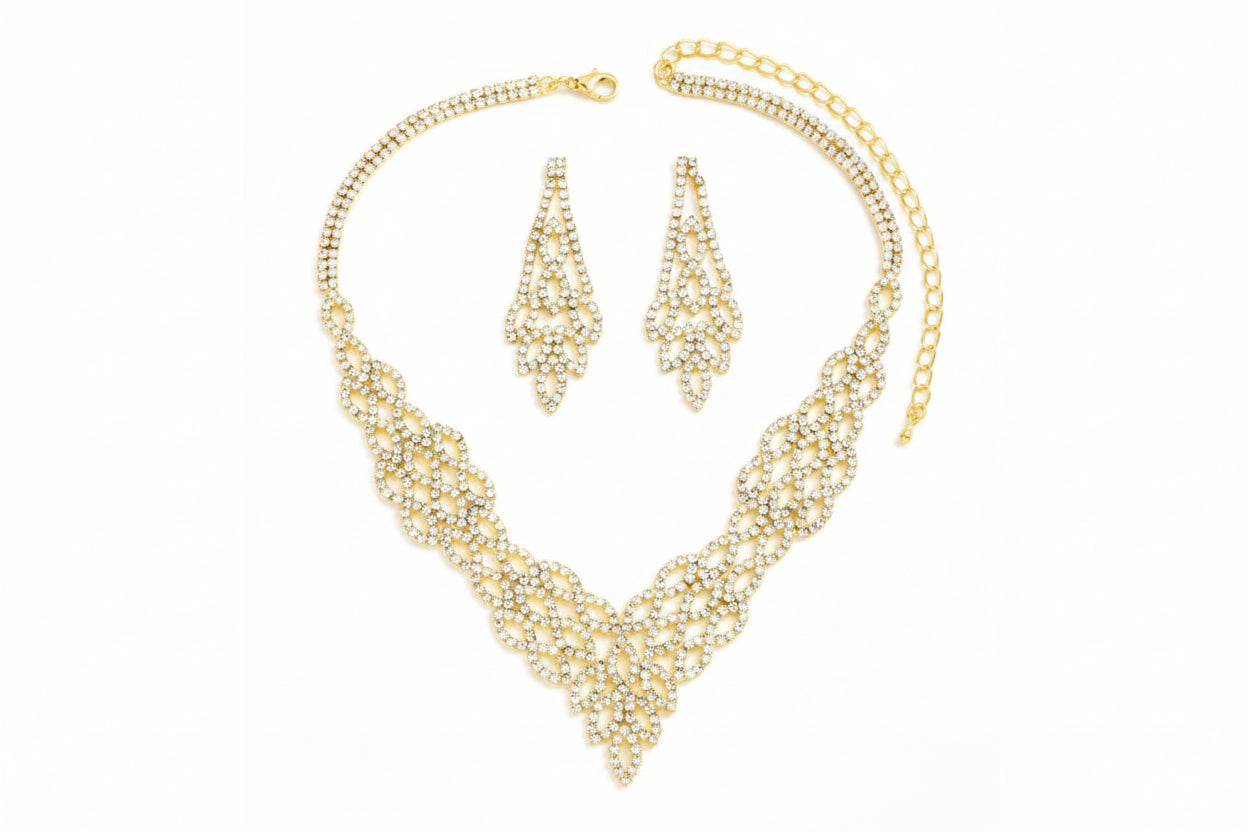 Gold necklace and earrings set on a white background
