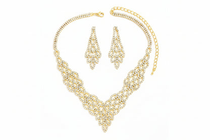 Gold necklace and earrings set on a white background